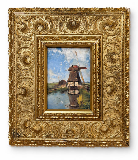 The Mill Pond giclée of a Dutch windmill reflected in still water under a blue sky, set in a deeply embossed antique gilt frame with floral and scroll detailing